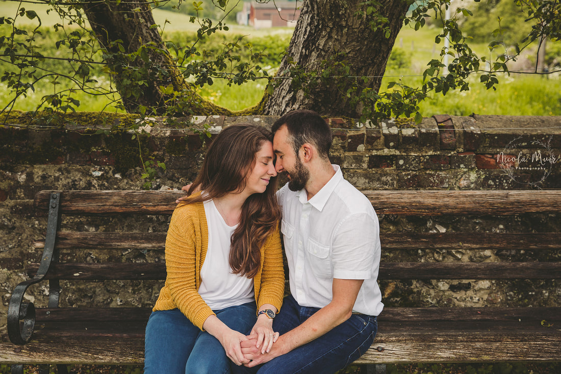 nicola muir photography pre wedding session upwaltham barns snuggle couple bench